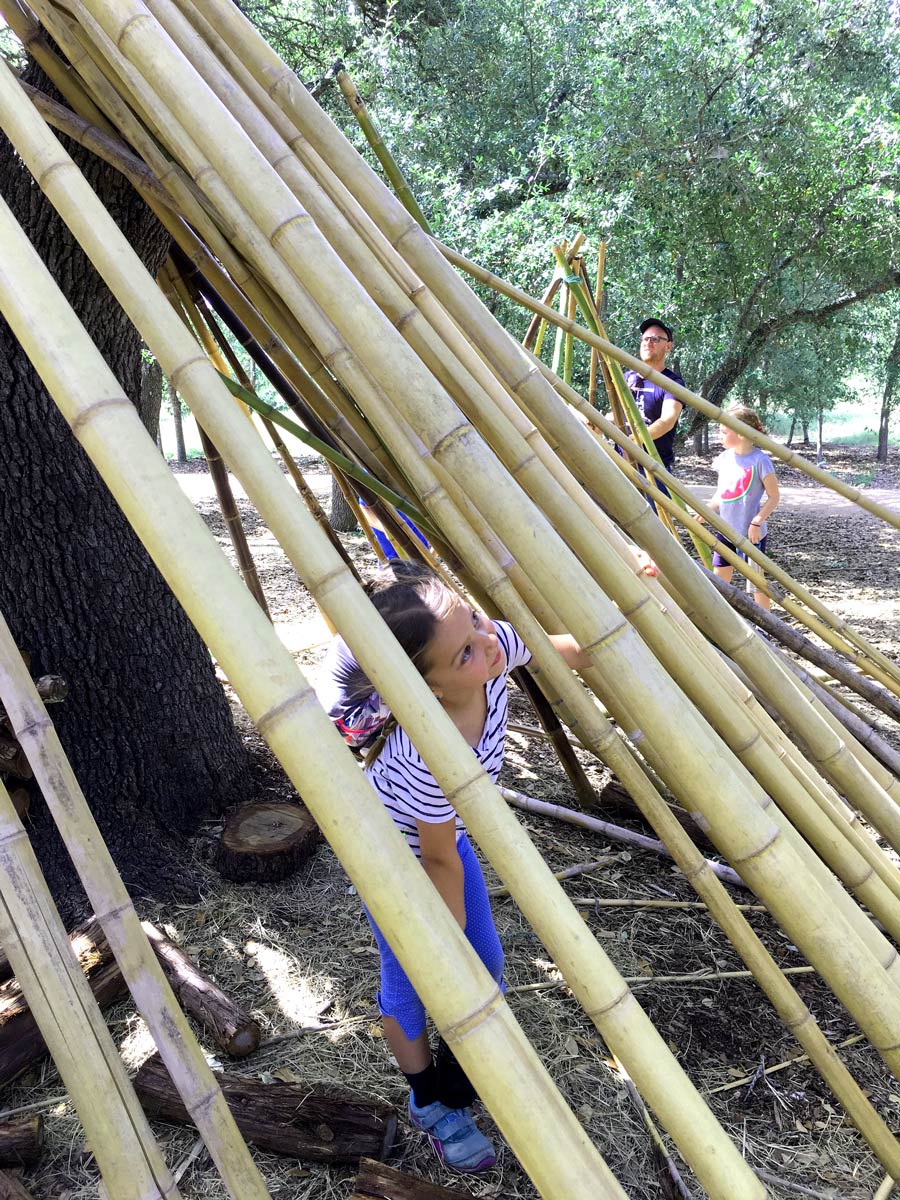Children learning about how to construct shelter made of bamboo at Camp Wildflower.