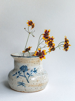 Stoneware with blue flower holding native flowers
