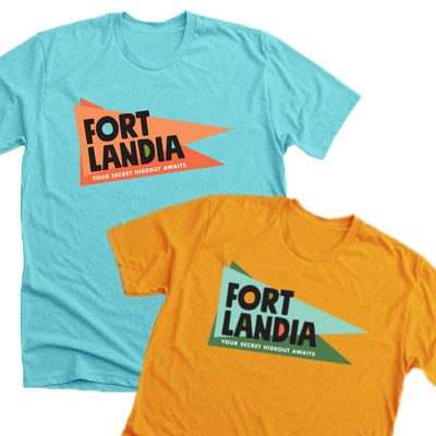 Two t-shirts with the Fortlandia logo, one is orange and one is light blue.