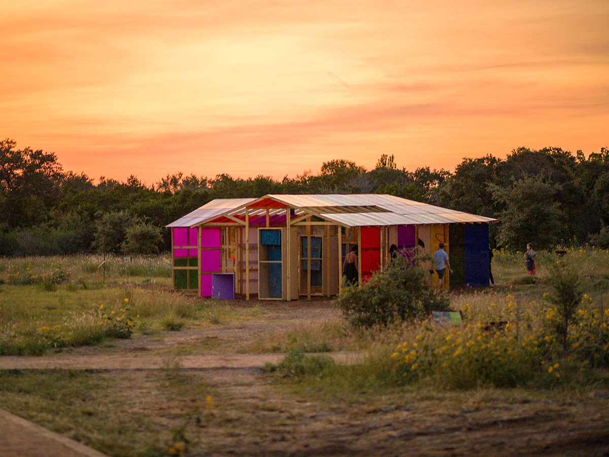 The multi colored Community Gardens fort under a orange sky at sunset.
