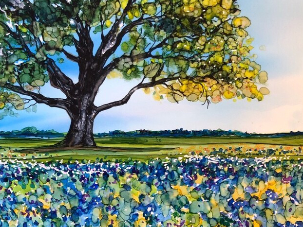 Painting of bluebonnets with alcohol ink, a blue sky and a large tree in the background.