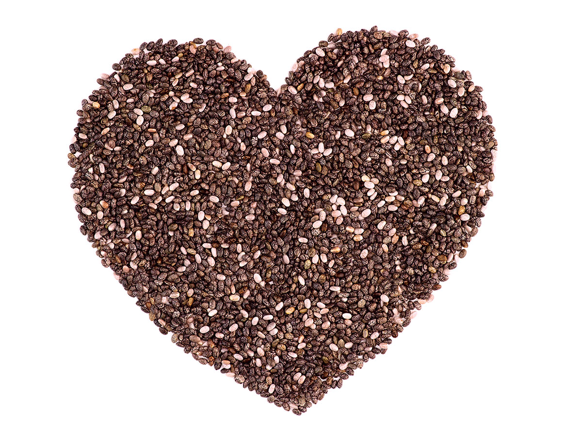Brown and white chia seeds laid out in the shape of a heart.
