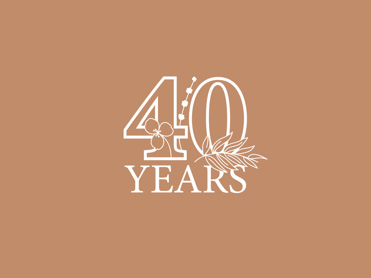 A logo for the Wildflower Center's 40th anniversary celebration, featuring a large white number 40 with flowers and grasses growing out of it against a dusty pink background.