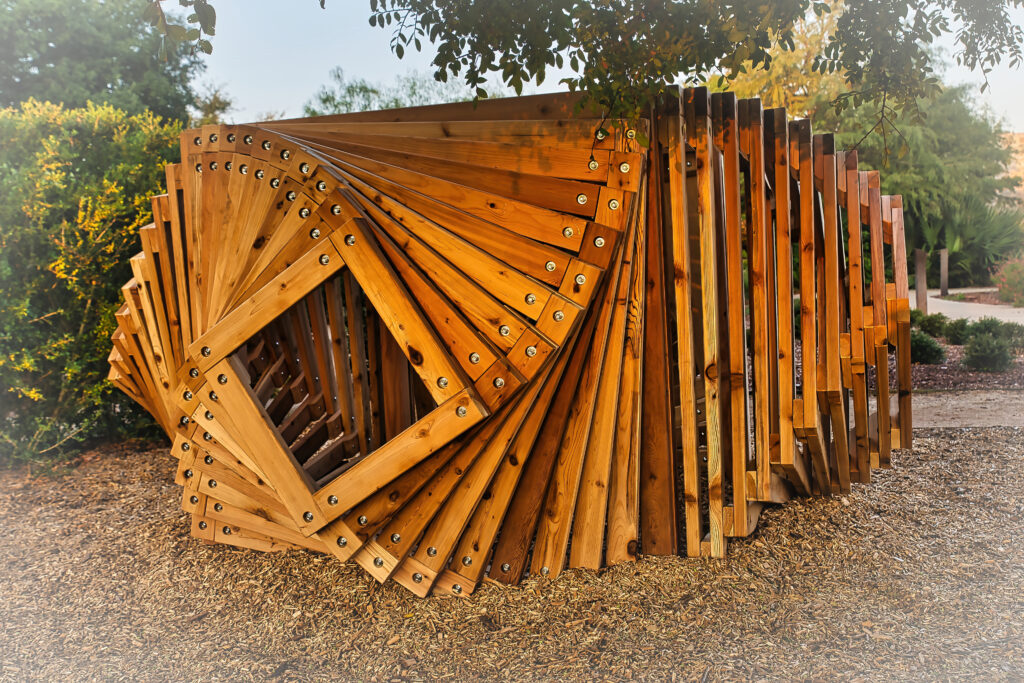 The Wormhole Fortlandia fort made of wooden boards arranged in a square spiral pattern